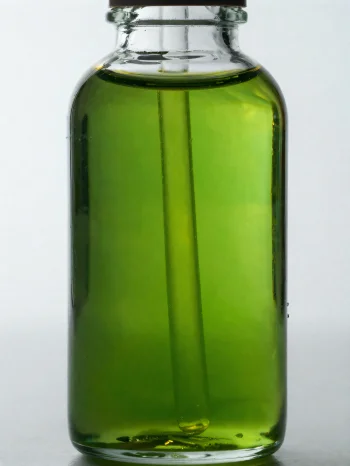 明るい背景に置かれた小瓶と小皿に入ったアボカドオイル